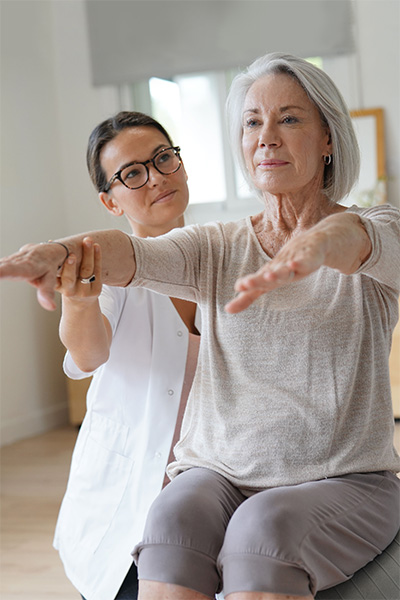 Rehab therapist with a resident in the rehab gym