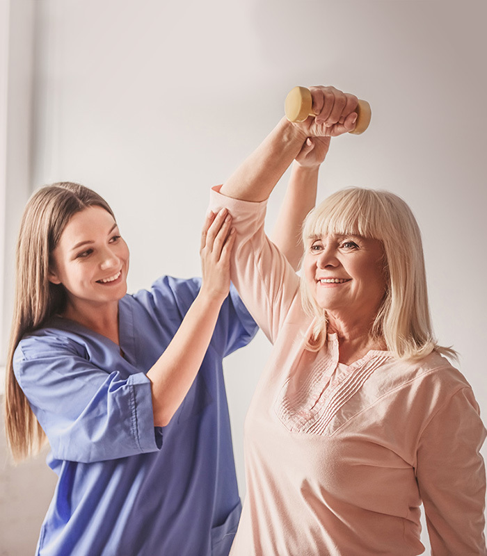 rehab nurse assisting elderly resident with an arm exercise