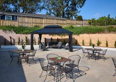 Back shaded seating area of the Encinitas Nursing and Rehab facility showing the courtyard